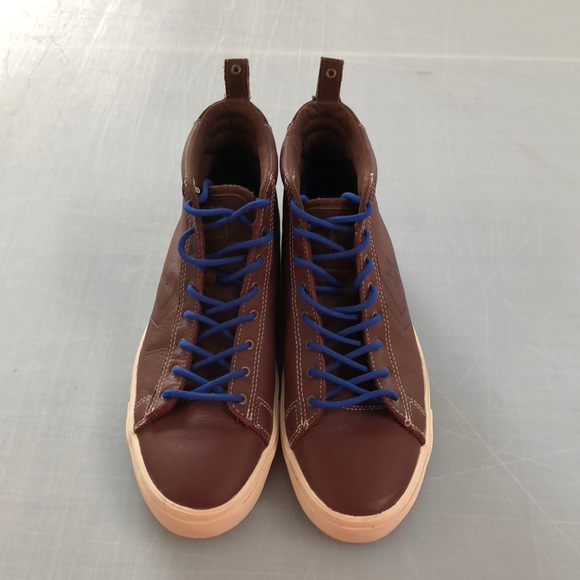 blue and brown leather converse